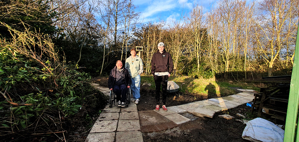 Missionaries ‘Shovel’ Support to Shape Woodland Garden